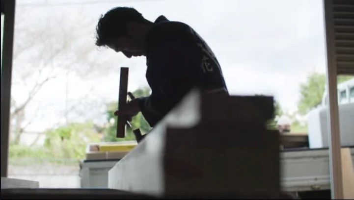 Un miyadaiku façonnant le bois